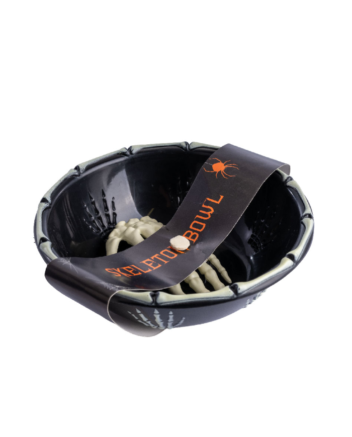 Black storage holder with plastic skeleton hand with hangtag/label