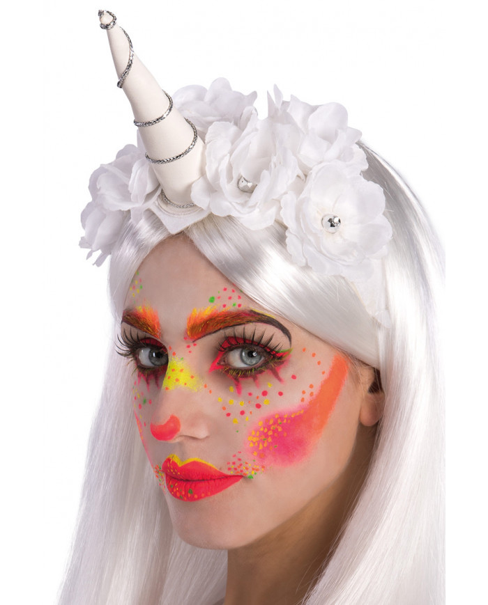 White unicorn headpiece decorated with flowers that is