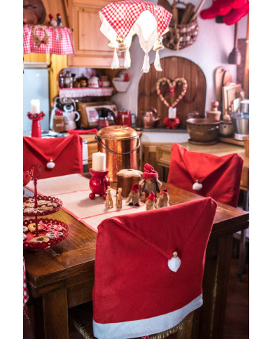 Red cover chair with pon pon and bell for a warm and welcoming